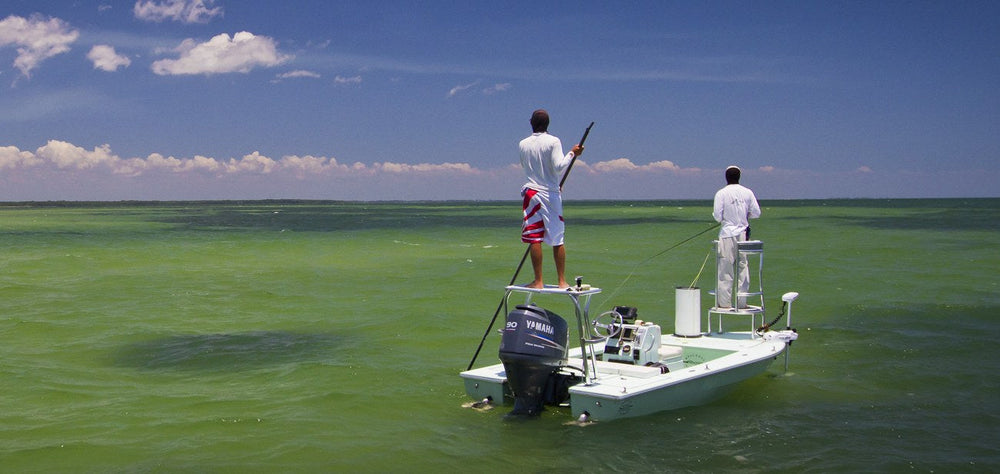 Waiting on the flats, two anglers on a skiff