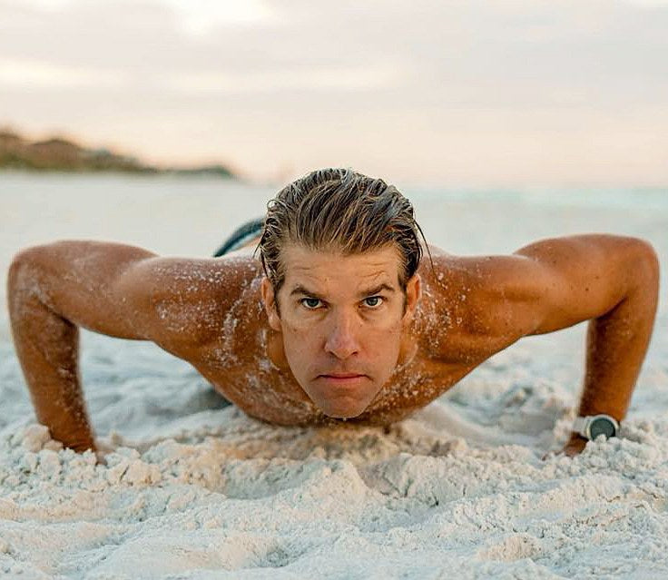 XPT coach Sean Miller doing push-ups on the sand