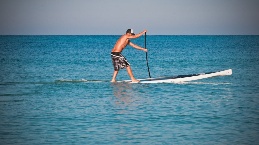Ingo Rademacher paddling a race board on flat water