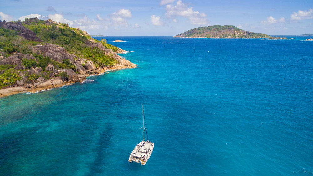 A catamaran anchored in clear tropical water
