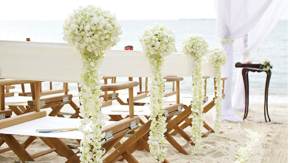 A beach wedding ceremony set up on the sand