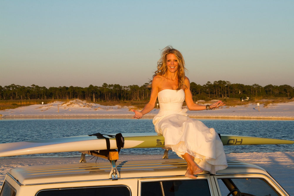 A bride sitting on the roof of a beach cruiser