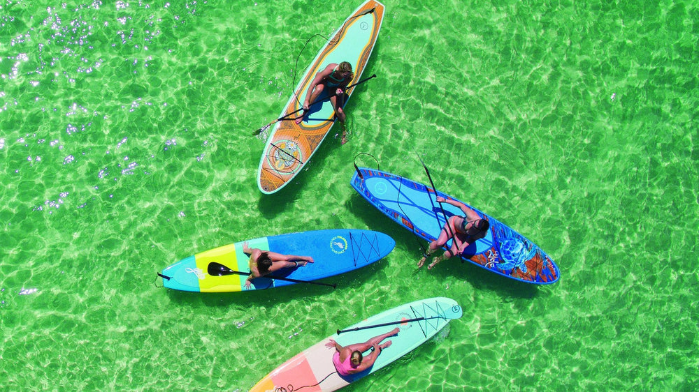 YOLO Board paddleboards from above in clear Gulf water