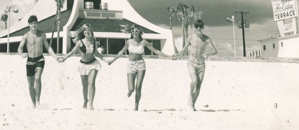 Beachgoers below the Miracle Strip Tower