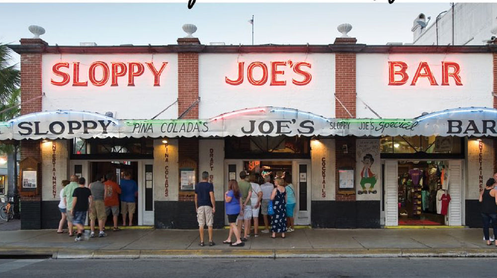 The neon-lit facade of Sloppy Joe's Bar on Duval Street, Key West