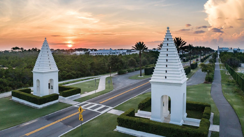 The twin white butteries marking the entrance to Alys Beach at sunset