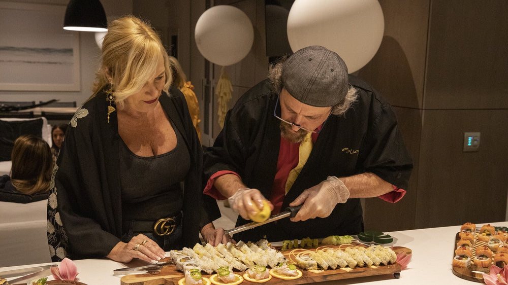 Jeff Margaretten and a guest plating sushi at a kitchen island