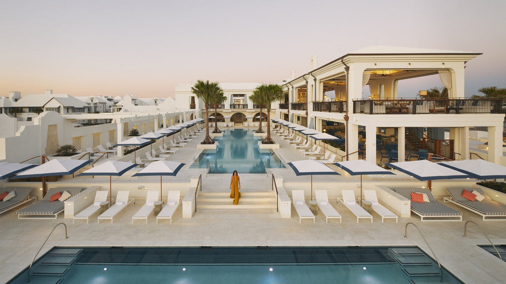 The infinity pool at the Alys Beach Club at dusk with white loungers