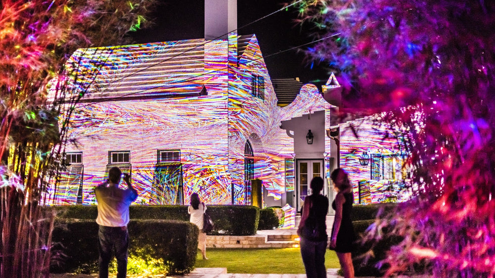 Projected art on the white walls of Alys Beach at night