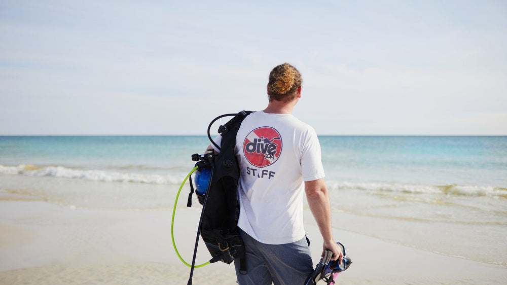 Walt Hartley walking to the water with dive gear on 30A