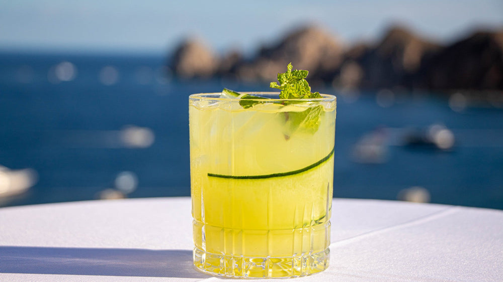 A zero-proof cocktail on a table above the water